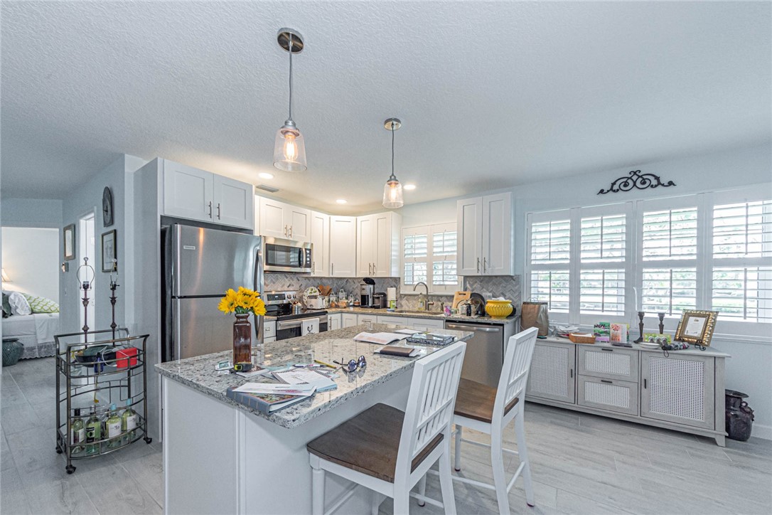 2800 Indian River Boulevard, Unit G6 Vero Beach, FL 32960 - Photo 7 of 22 a kitchen with appliances a counter top space cabinets and a window