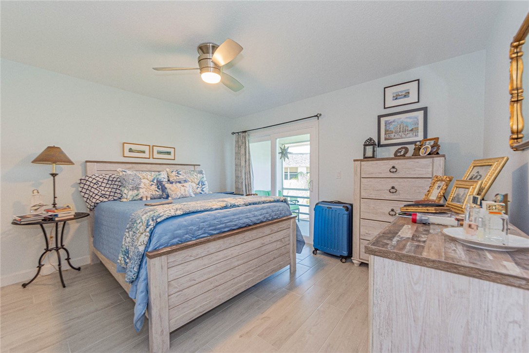 2800 Indian River Boulevard, Unit G6 Vero Beach, FL 32960 - Photo 10 of 22 a bedroom with a bed and wooden floor