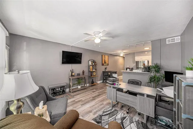 a kitchen with a refrigerator a stove a sink cabinets and wooden floor