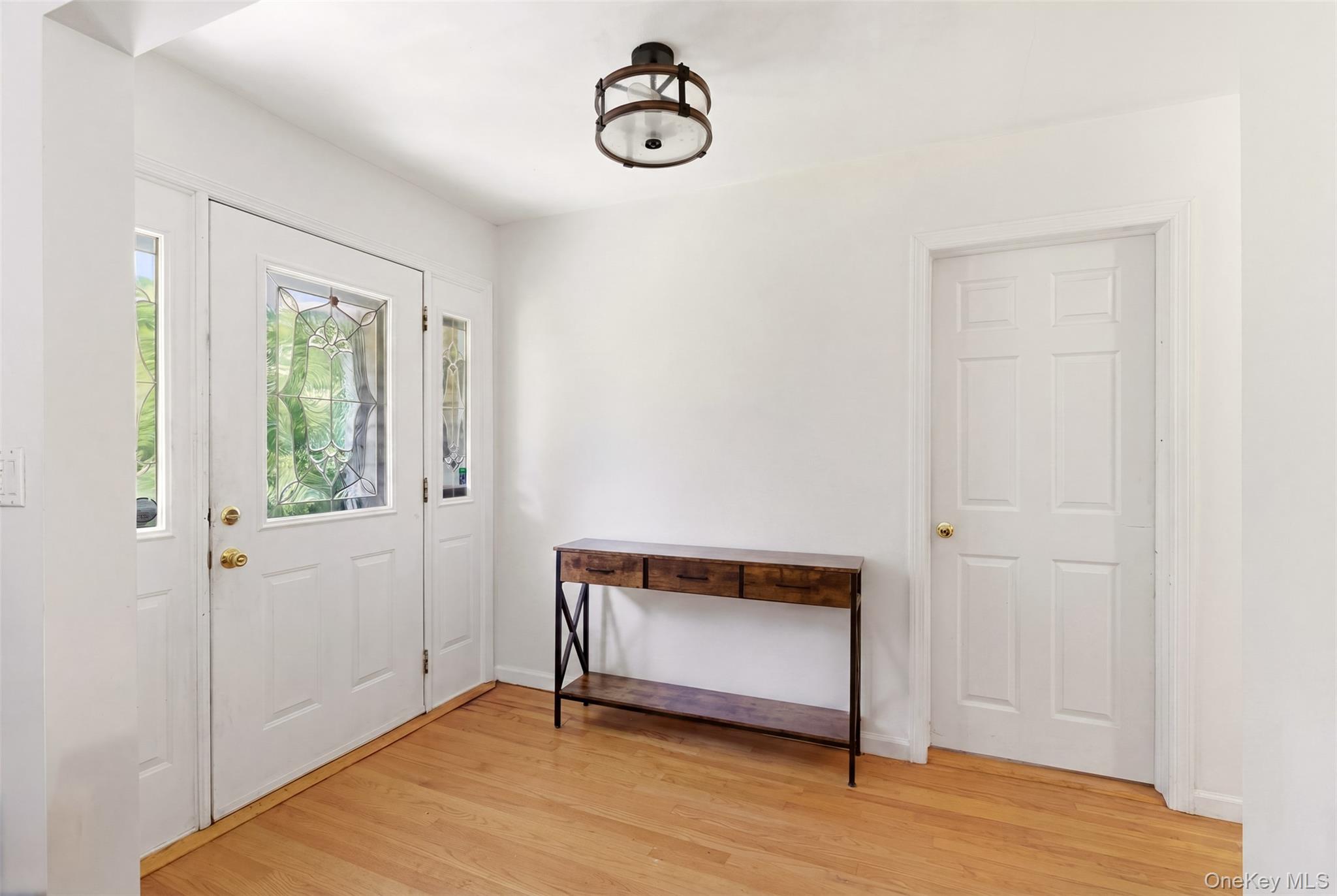 106 Vineyard Road Huntington, NY 11743 - Photo 3 of 25 a view of an empty room with window and wooden floor