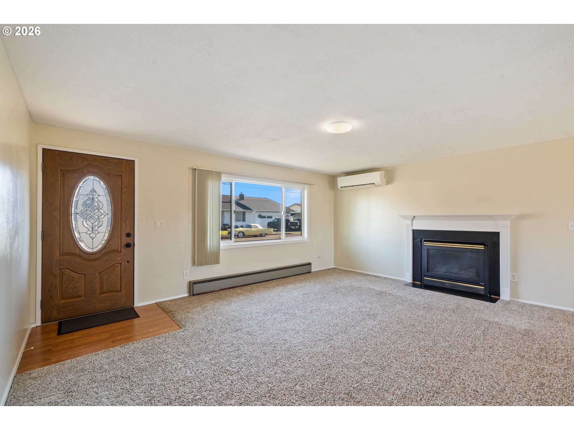 702 Ash Avenue Tillamook, OR 97141 - Photo 7 of 27 a view of an empty room with window and fire place