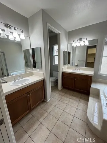a bathroom with a sink double vanity granite and a mirror