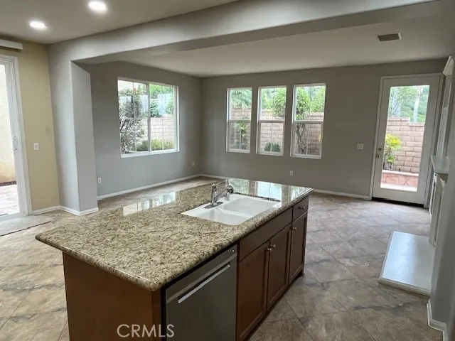 a bathroom with a granite countertop sink and window