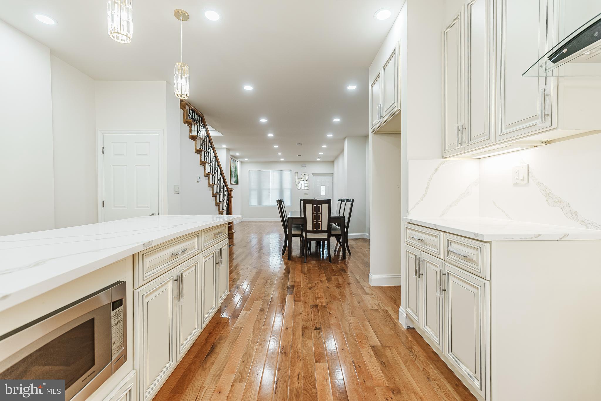 a kitchen with granite countertop white cabinets and white appliances