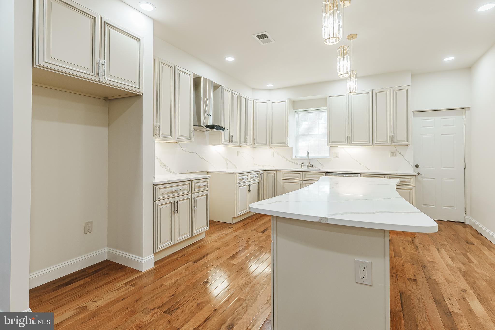 6357 Old York Road Philadelphia, PA 19141 - Photo 2 of 41 a kitchen with kitchen island a stove a sink and a refrigerator