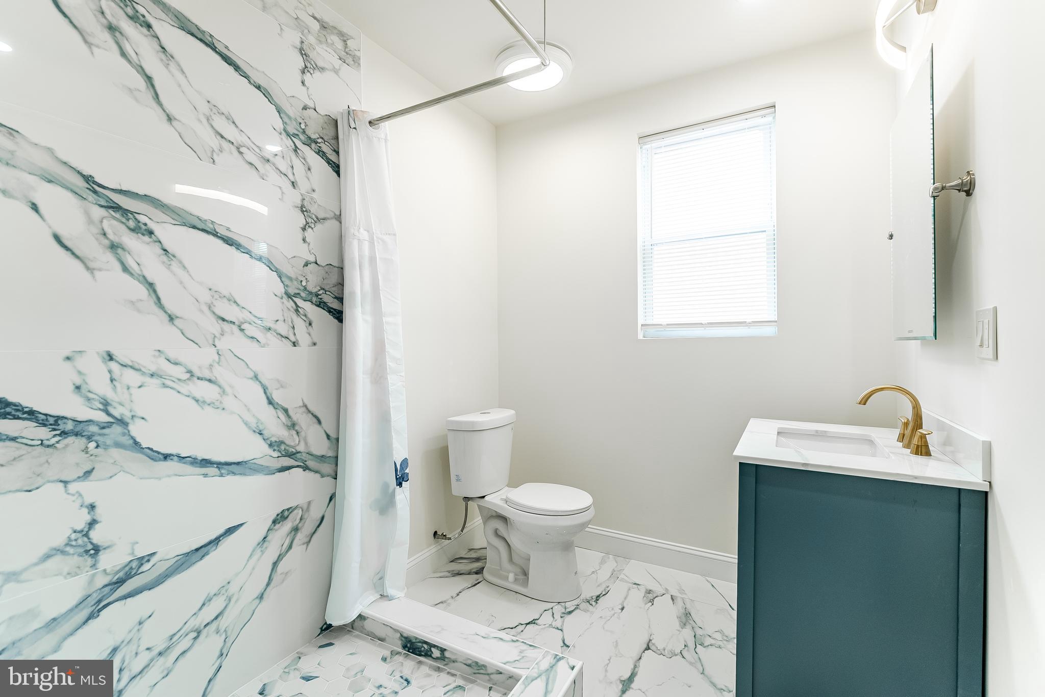 6357 Old York Road Philadelphia, PA 19141 - Photo 22 of 41 a bathroom with a sink toilet and shower