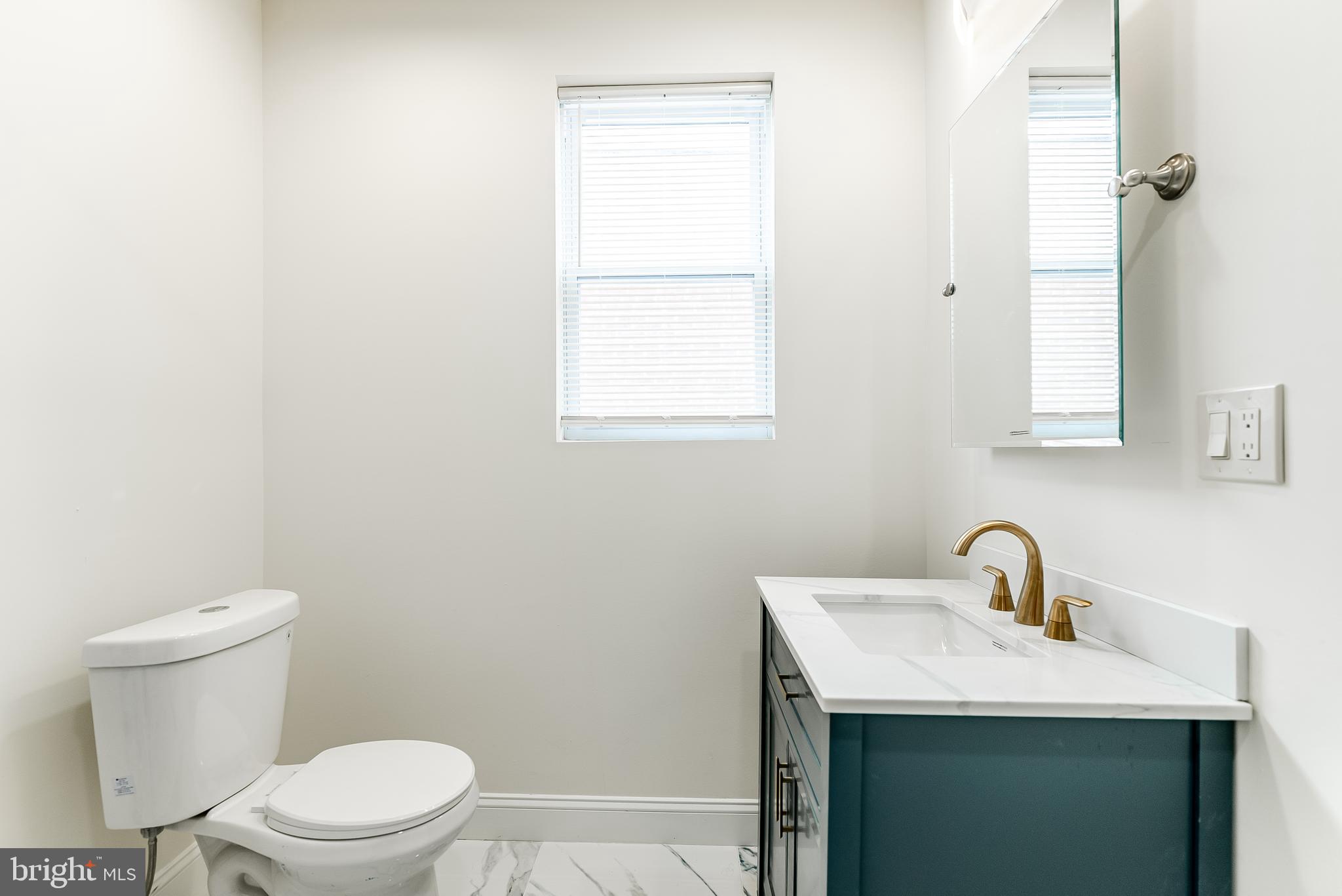 6357 Old York Road Philadelphia, PA 19141 - Photo 23 of 41 a bathroom with a sink and a toilet