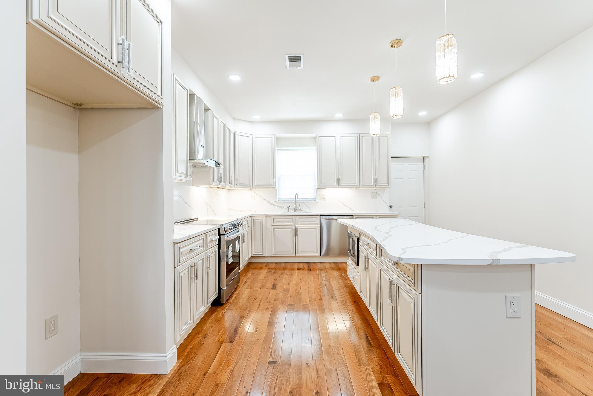 6357 Old York Road Philadelphia, PA 19141 - Photo 3 of 41 a view of a kitchen with a sink and wooden floor