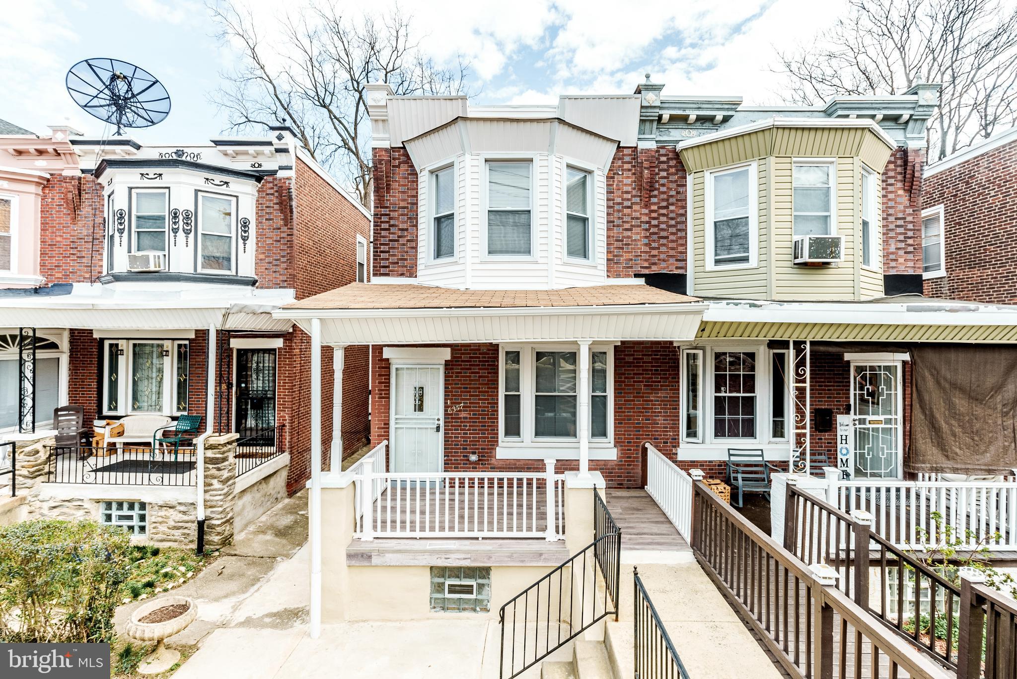 6357 Old York Road Philadelphia, PA 19141 - Photo 34 of 41 a front view of a residential apartment building with a bench