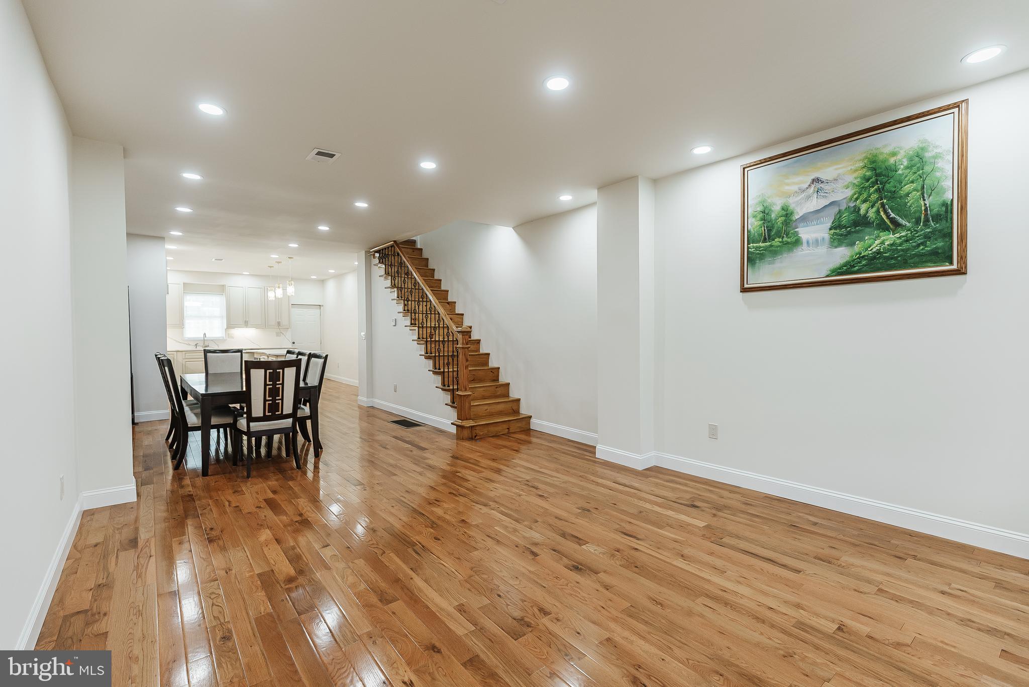 6357 Old York Road Philadelphia, PA 19141 - Photo 38 of 41 a view of a dining hall with a dining table chairs and wooden floor
