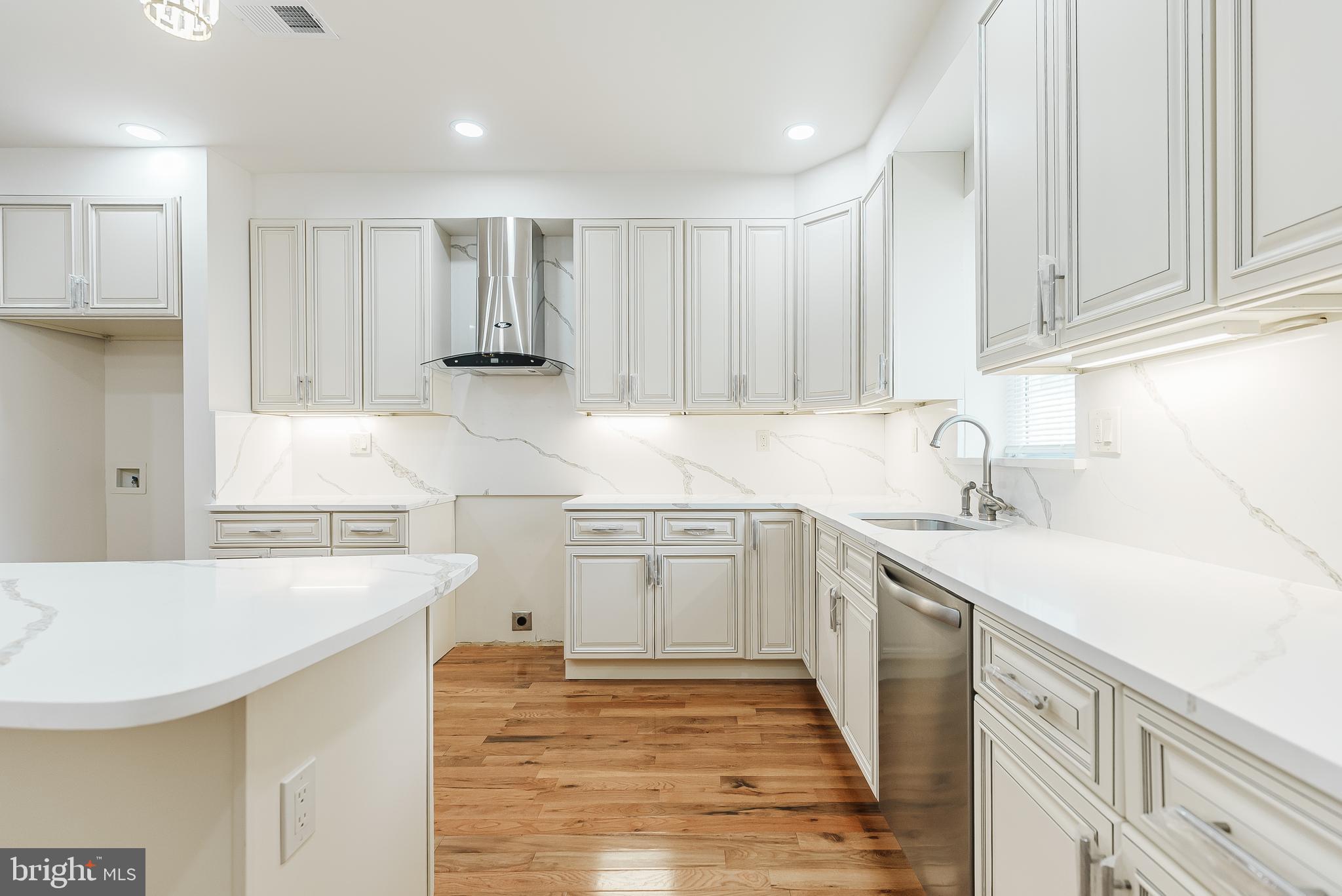 6357 Old York Road Philadelphia, PA 19141 - Photo 4 of 41 a kitchen with a sink a stove a refrigerator and white cabinets