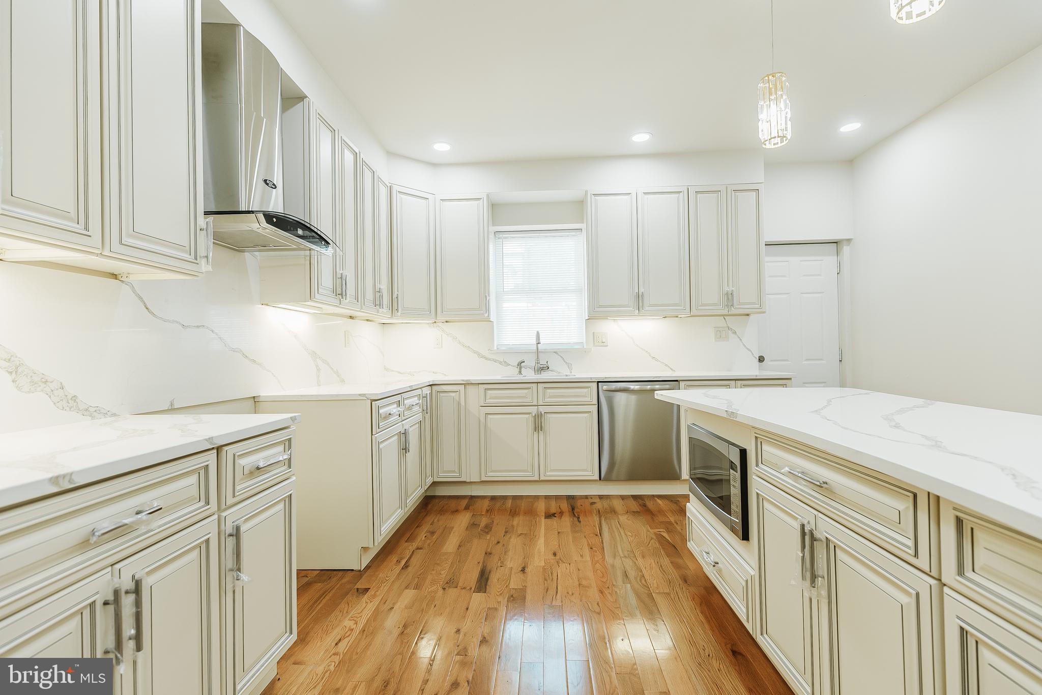 6357 Old York Road Philadelphia, PA 19141 - Photo 5 of 41 a kitchen with white cabinets stove and sink