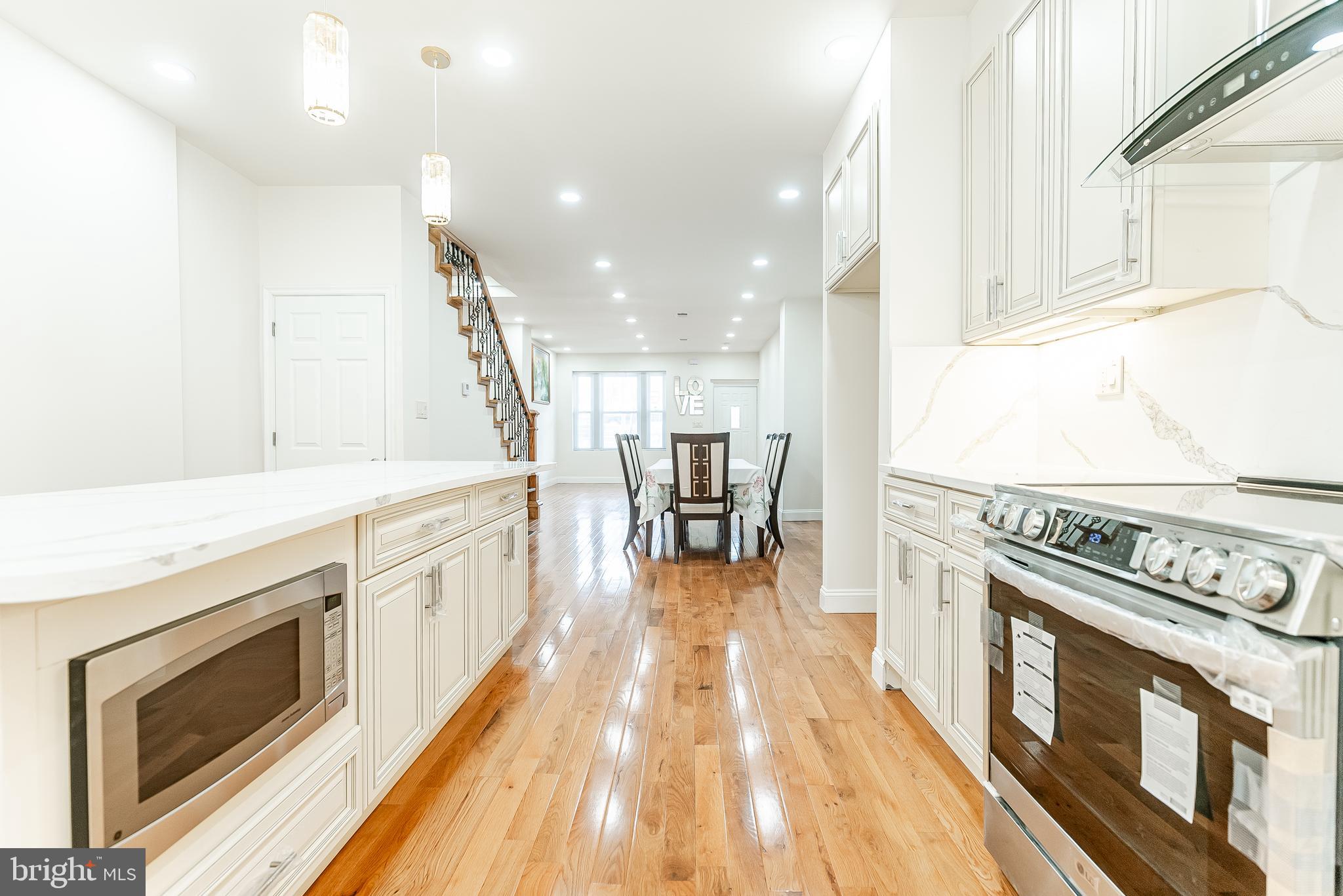 6357 Old York Road Philadelphia, PA 19141 - Photo 8 of 41 a kitchen with stainless steel appliances granite countertop a stove and a wooden floors