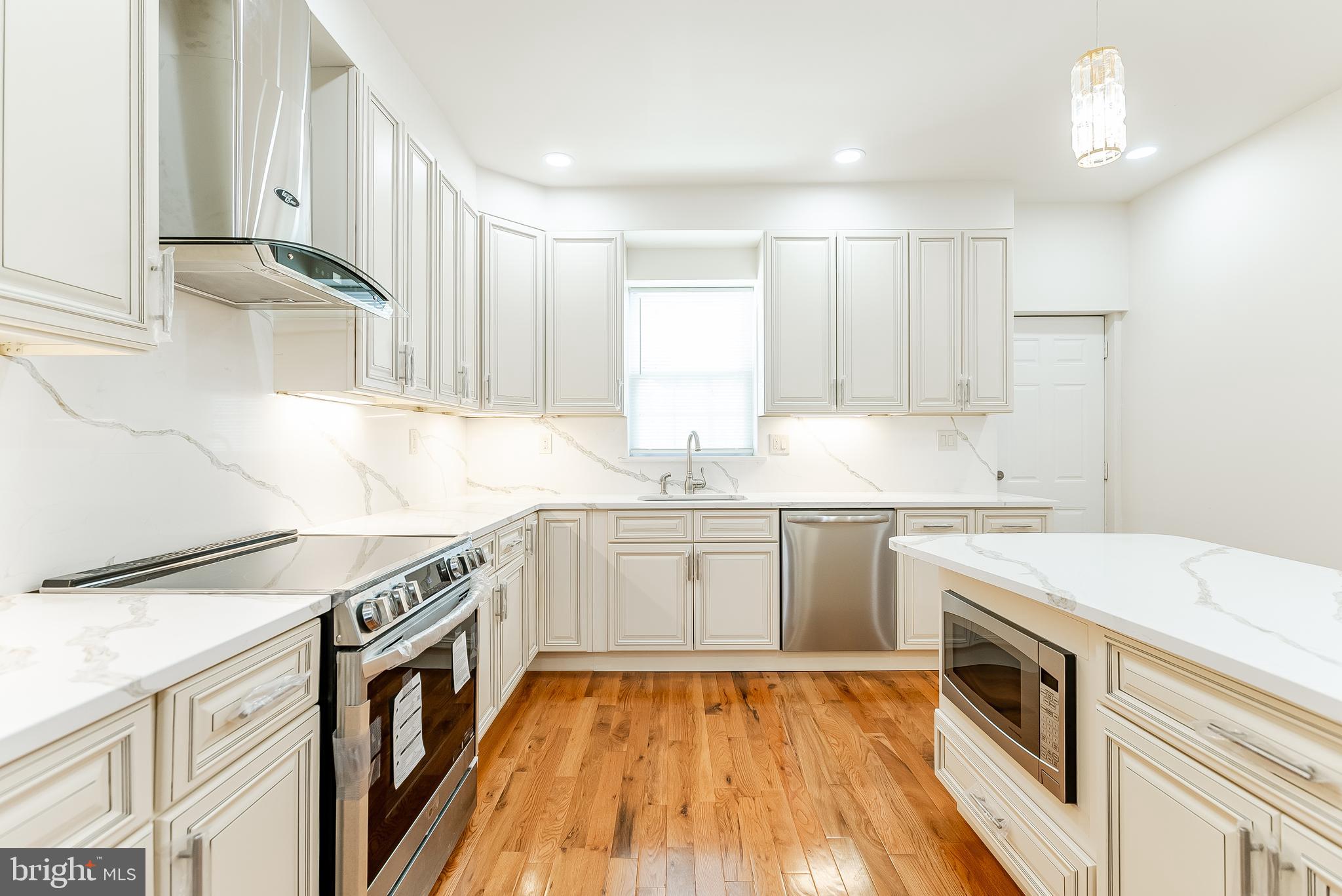 6357 Old York Road Philadelphia, PA 19141 - Photo 9 of 41 a kitchen with a sink stove top oven and cabinets