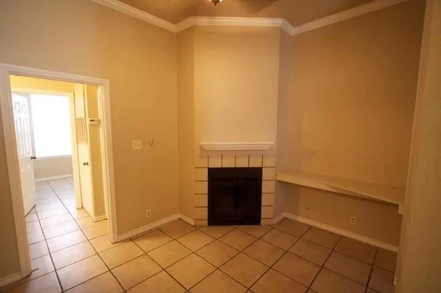 a view of empty room with a fireplace