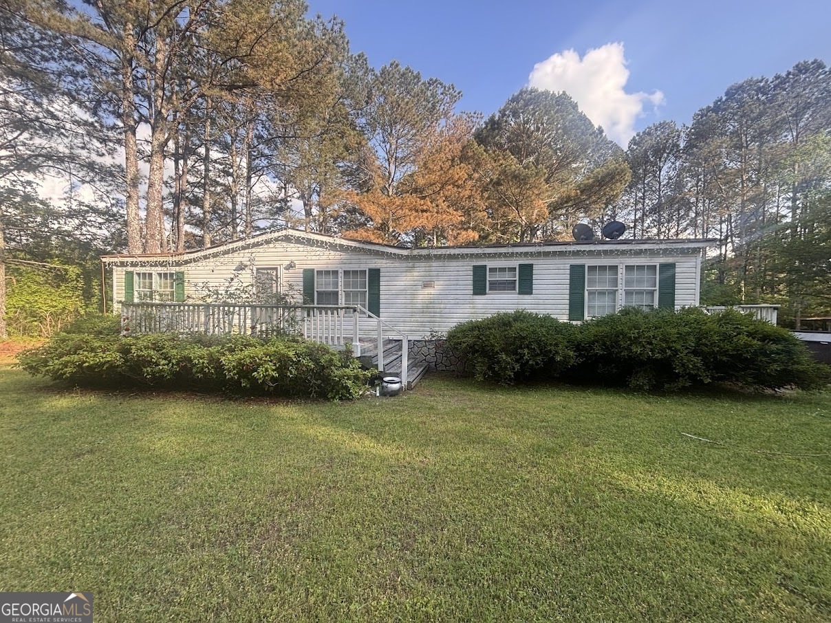 387 Simms Road Carrollton, GA 30117 - Photo 1 of 1 a front view of a house with garden