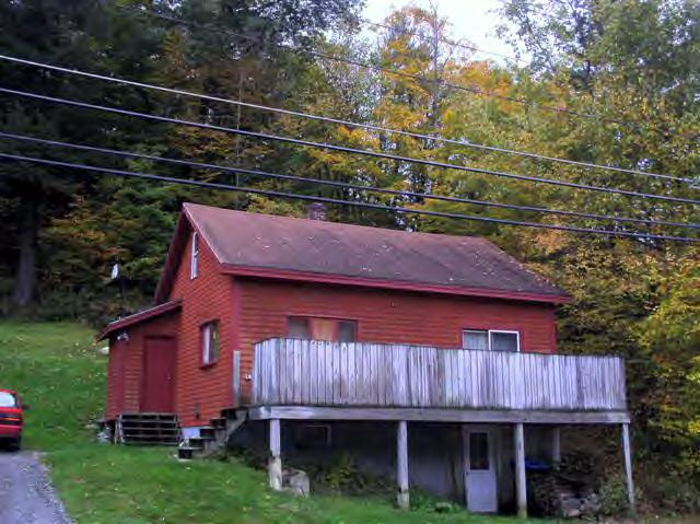 456 River Road Clarksburg, MA 01247 - Photo 1 of 1 a view of a house with a roof deck and wooden fence