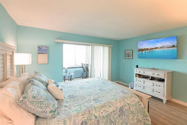 a bedroom with a bed and a dresser in it