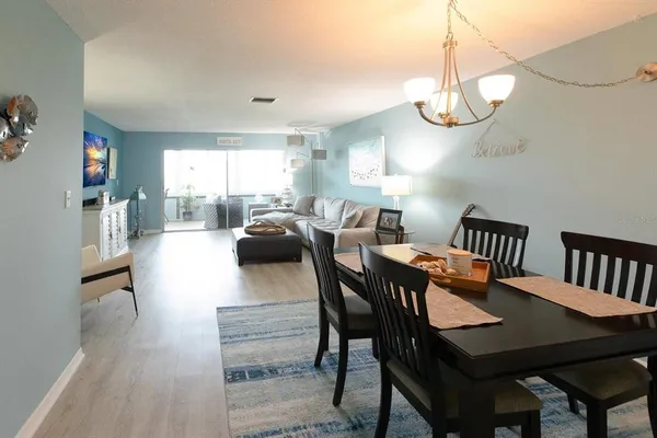 a view of a dining room with furniture window and wooden floor
