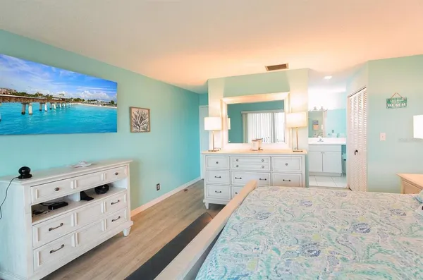 a bedroom with a bed and a dresser