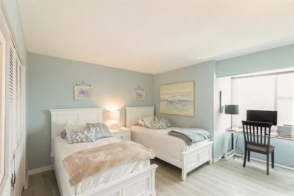 a bedroom with furniture and a large window