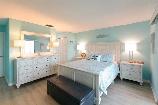 a bedroom with a bed and a dresser