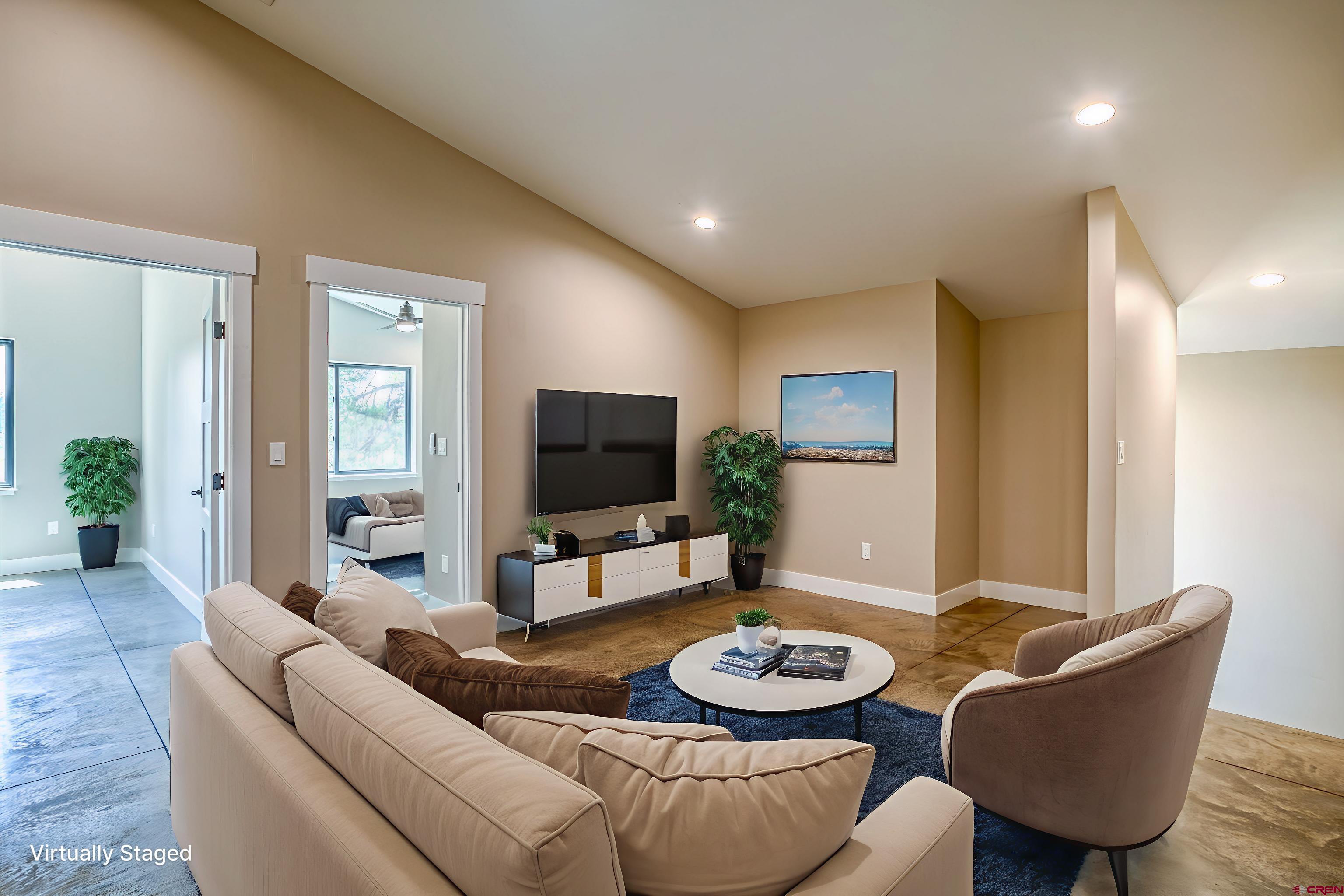 2790 Rock Road, Unit C Pagosa Springs, CO 81147 - Photo 13 of 44 a living room with furniture and a flat screen tv