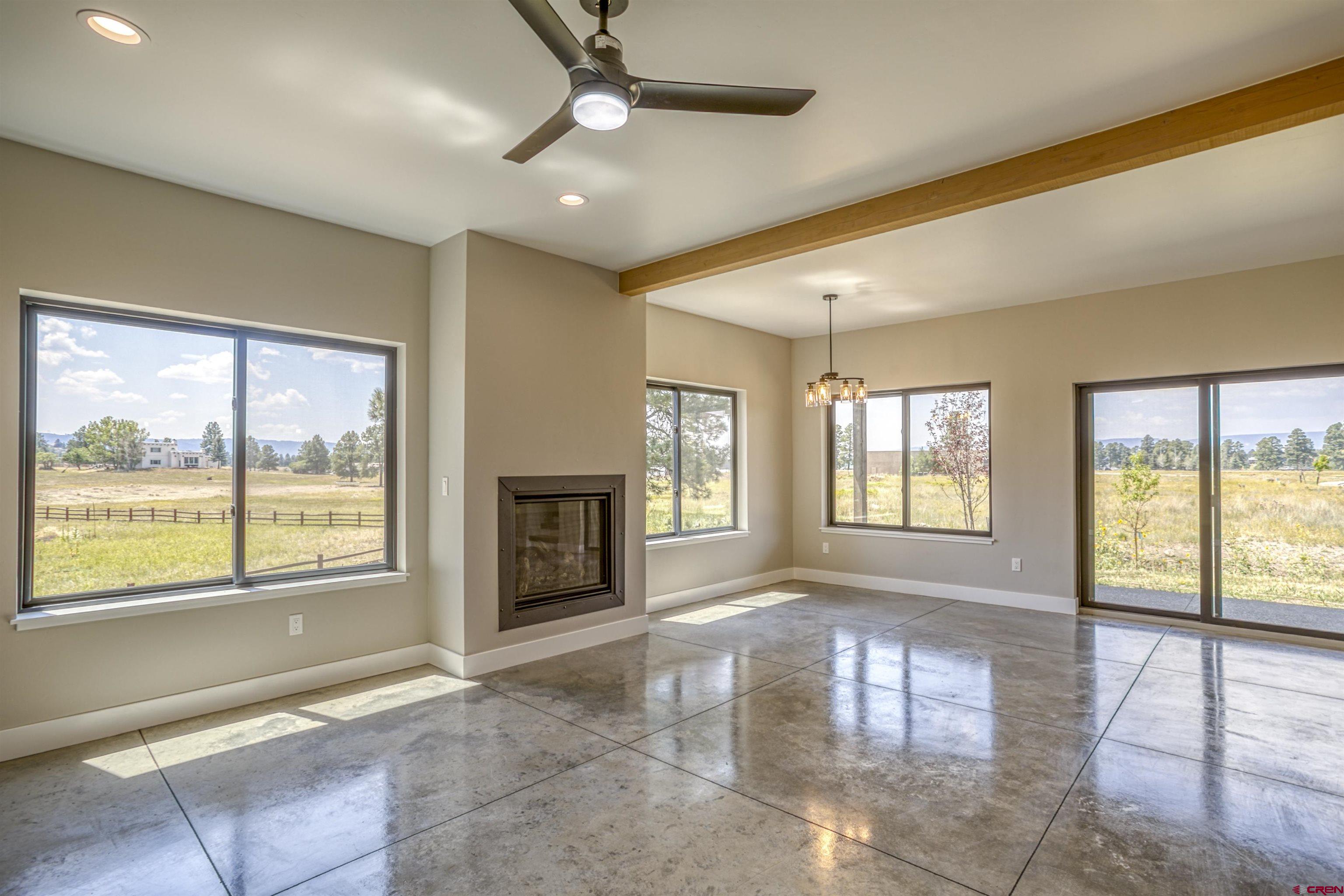 2790 Rock Road, Unit C Pagosa Springs, CO 81147 - Photo 16 of 44 a view of an empty room with a fireplace and a window