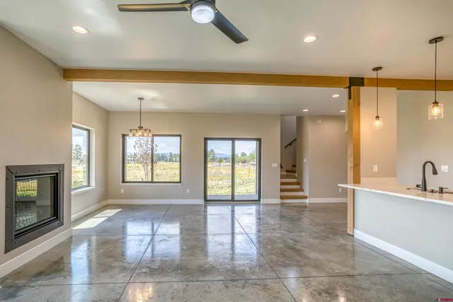 a view of an empty room with a fireplace and a window
