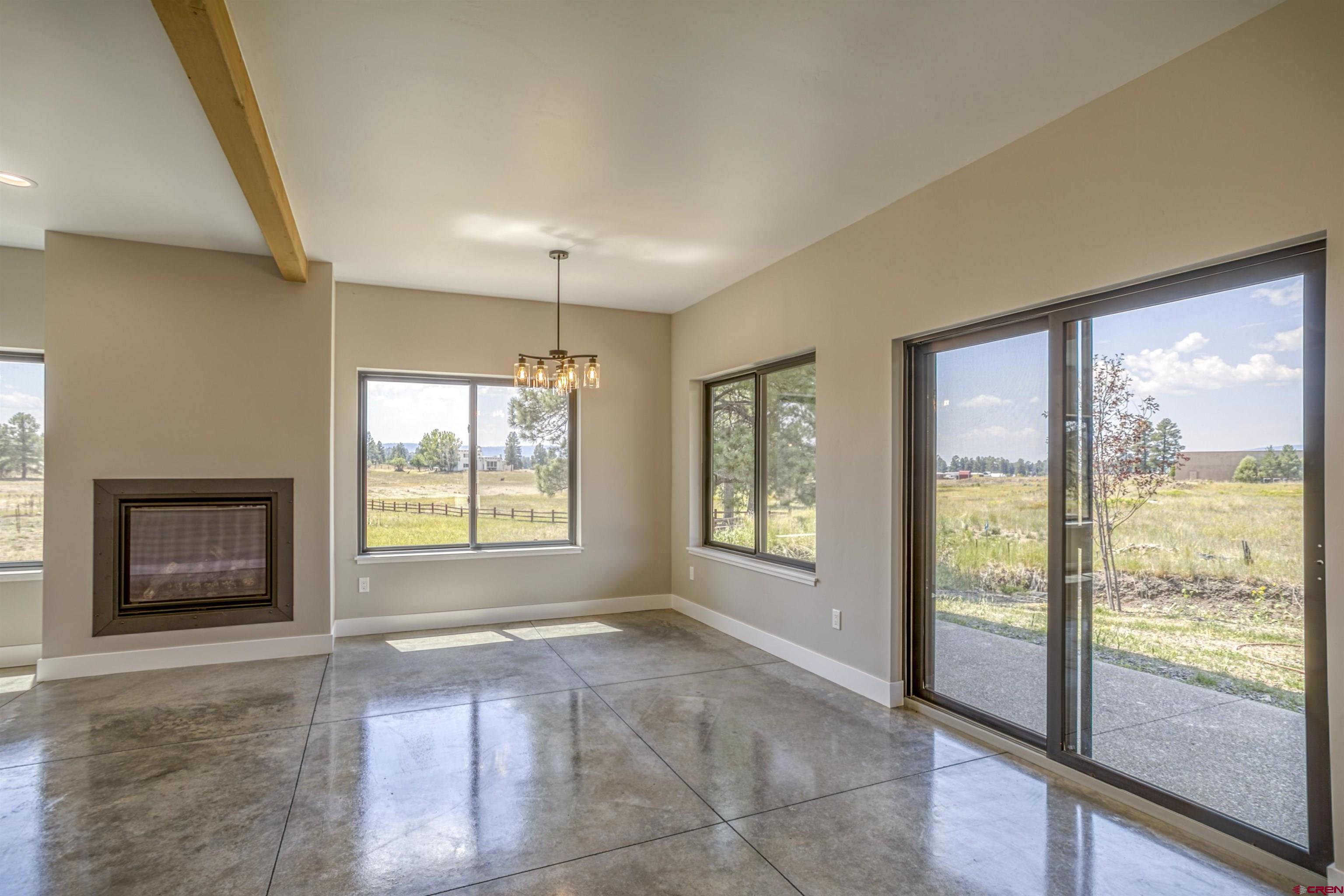 2790 Rock Road, Unit C Pagosa Springs, CO 81147 - Photo 18 of 44 a view of an empty room with a fireplace and a window