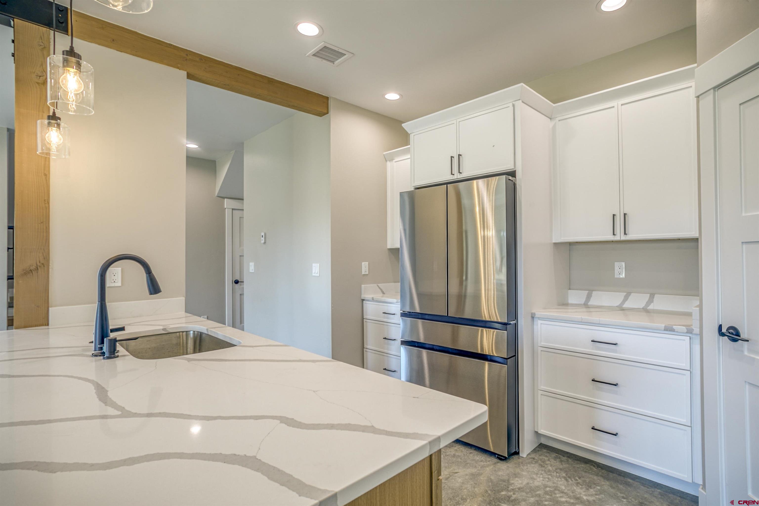 2790 Rock Road, Unit C Pagosa Springs, CO 81147 - Photo 19 of 44 a kitchen with stainless steel appliances a refrigerator and sink