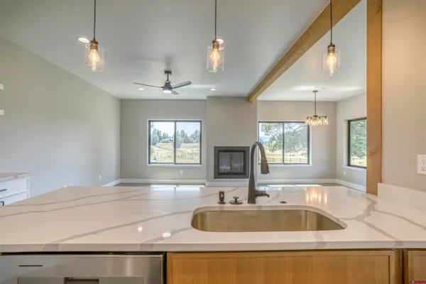 a kitchen with stainless steel appliances granite countertop a sink a stove and a wooden floors