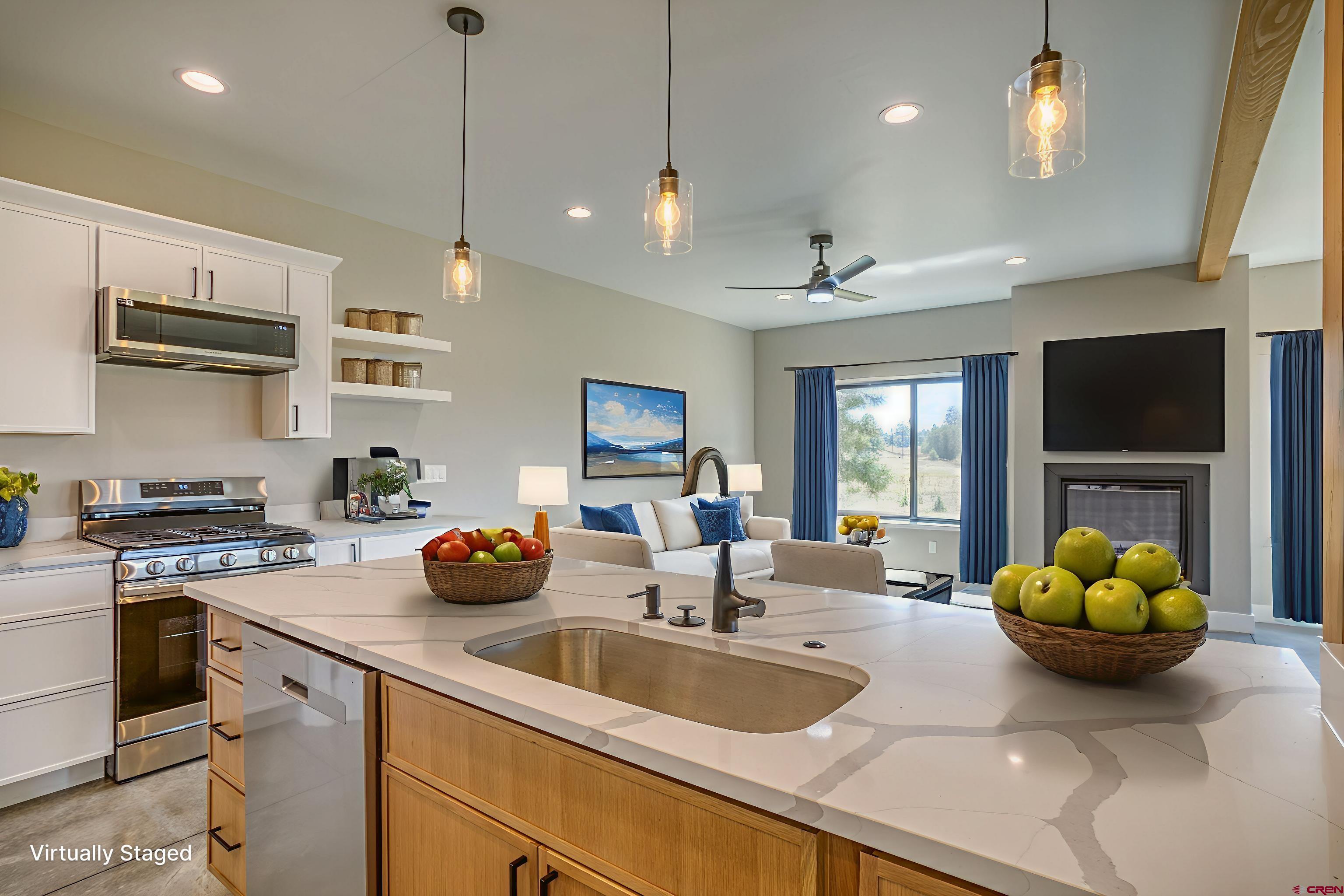 2790 Rock Road, Unit C Pagosa Springs, CO 81147 - Photo 21 of 44 a kitchen with stainless steel appliances granite countertop a sink a stove and a wooden floors