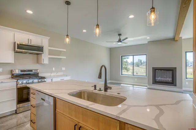 a view of a kitchen with a sink and a stove top oven