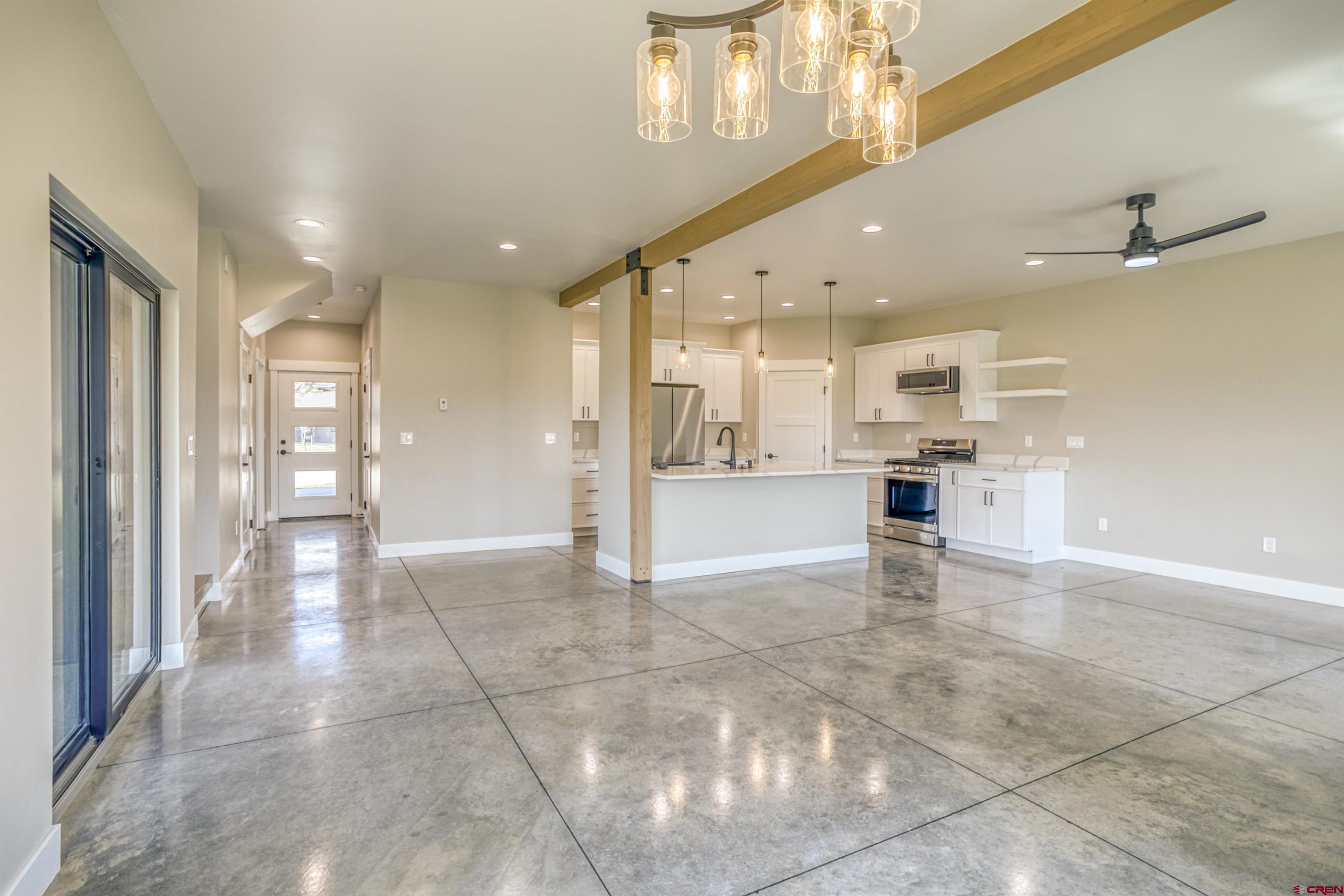 2790 Rock Road, Unit C Pagosa Springs, CO 81147 - Photo 26 of 44 a view of a hallway with stainless steel appliances kitchen island granite countertop a refrigerator and a stove top oven