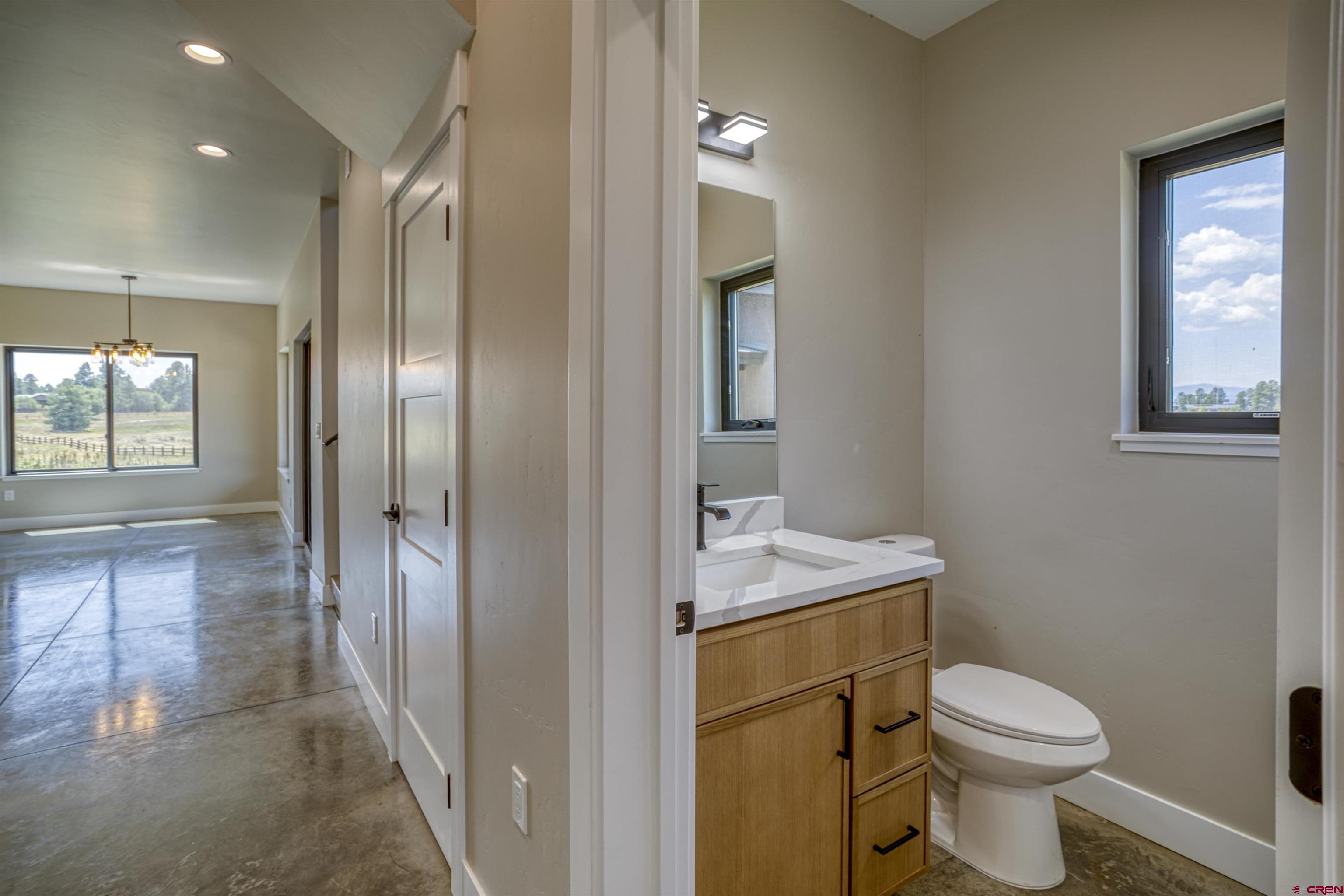 2790 Rock Road, Unit C Pagosa Springs, CO 81147 - Photo 30 of 44 a bathroom with a toilet sink and mirror