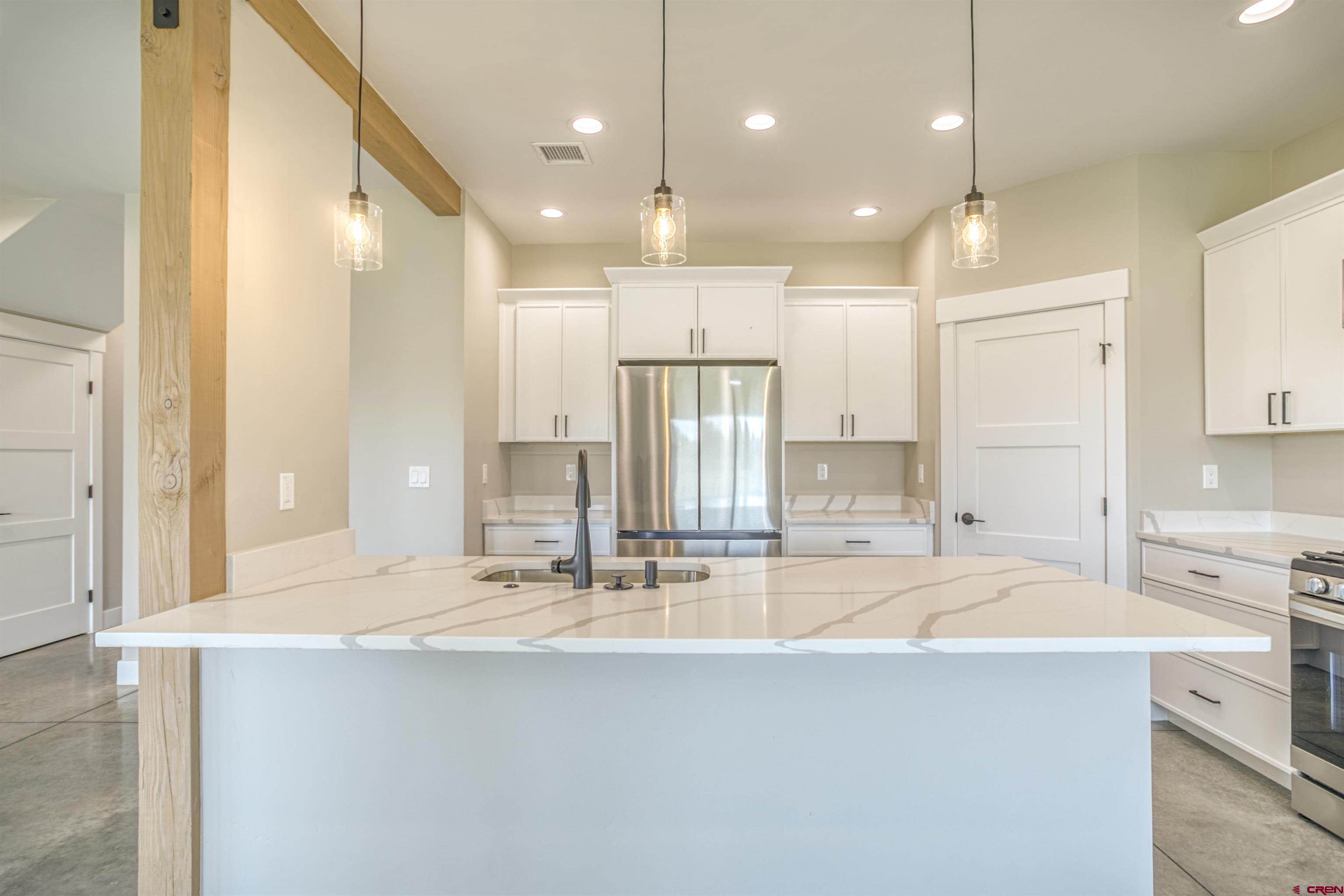 2790 Rock Road, Unit C Pagosa Springs, CO 81147 - Photo 31 of 44 a large kitchen with kitchen island a sink stainless steel appliances and cabinets