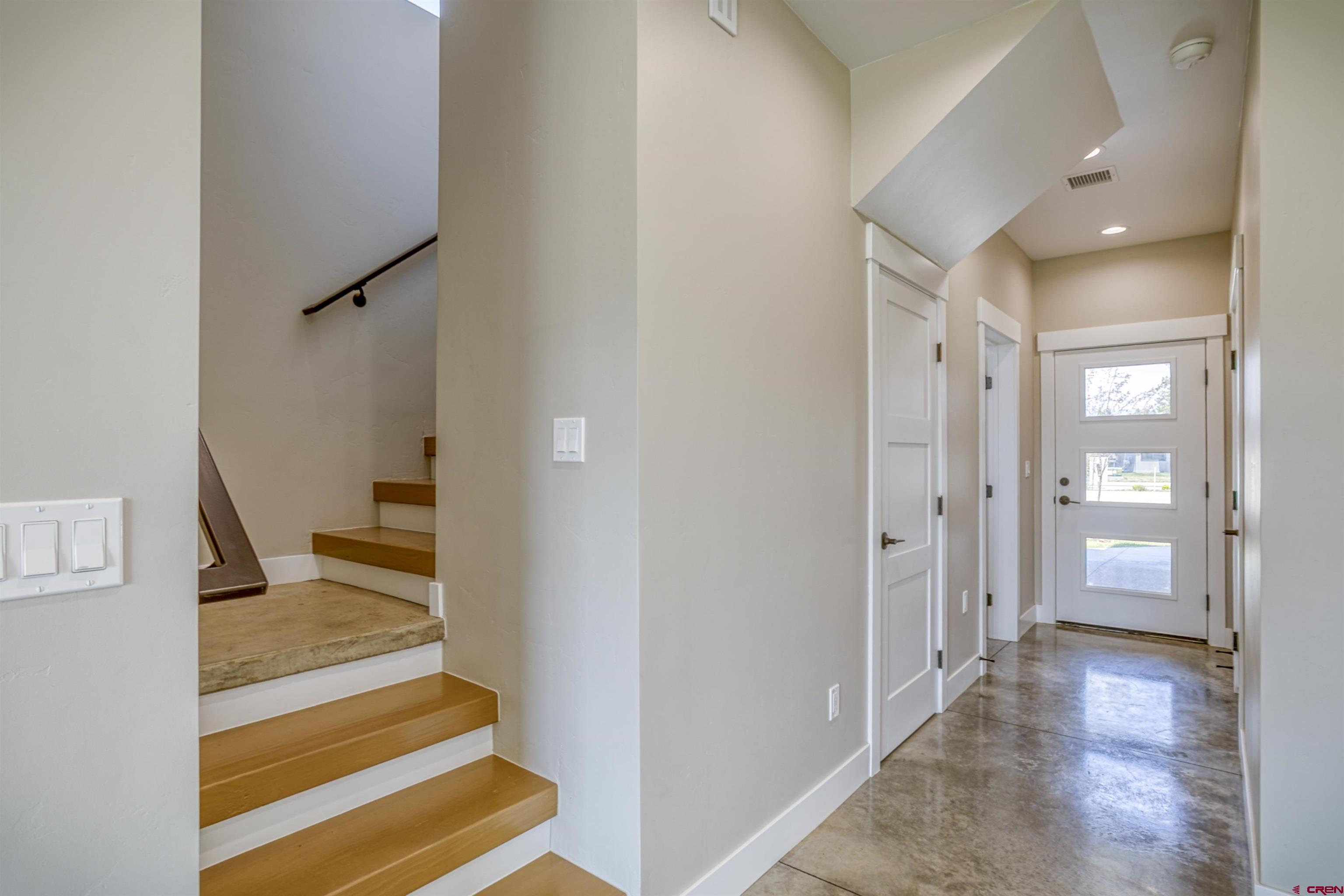 2790 Rock Road, Unit C Pagosa Springs, CO 81147 - Photo 32 of 44 a view of a hallway with wooden floor and staircase