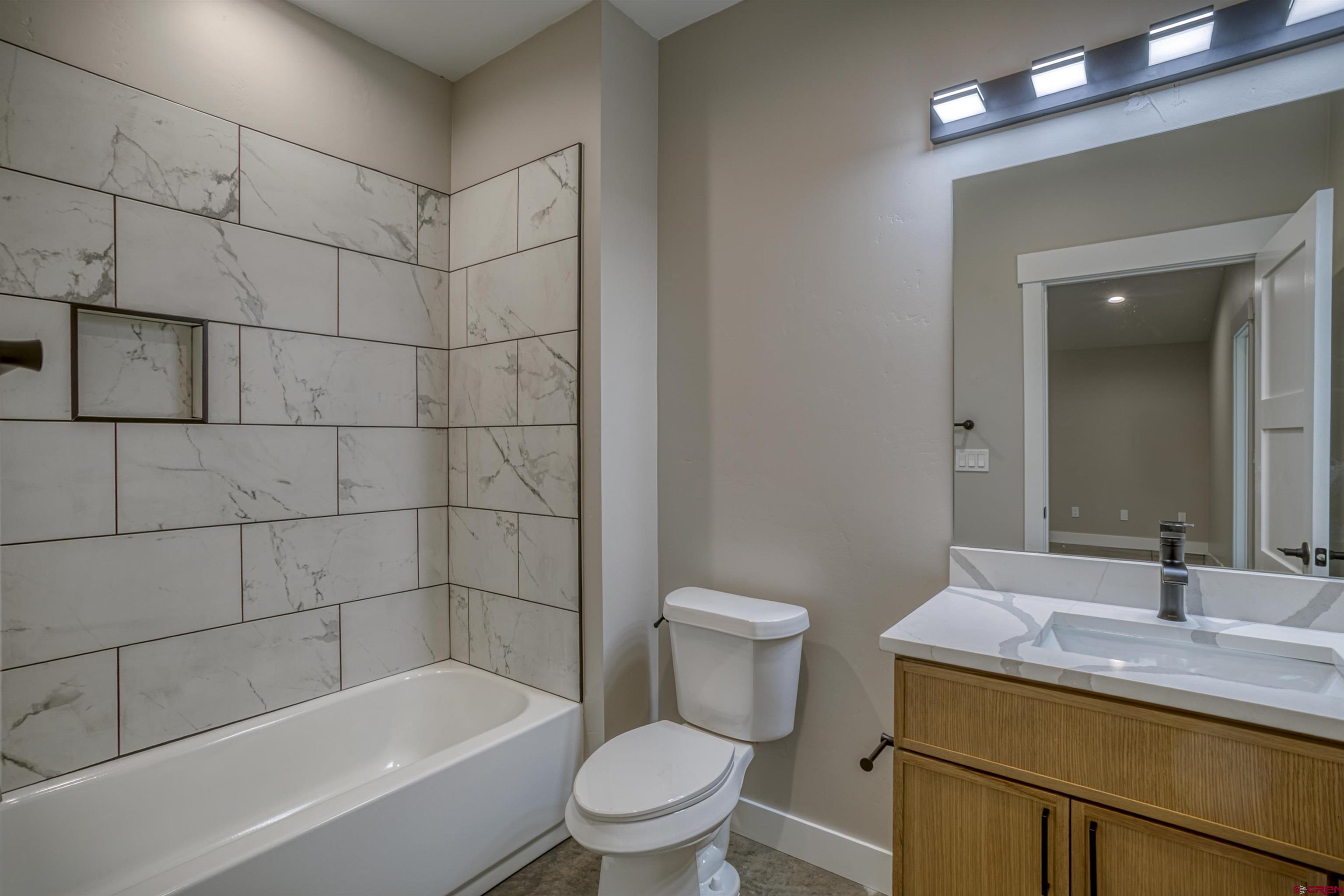2790 Rock Road, Unit C Pagosa Springs, CO 81147 - Photo 37 of 44 a bathroom with a sink a toilet and shower