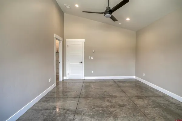 a view of a hallway with a ceiling fan