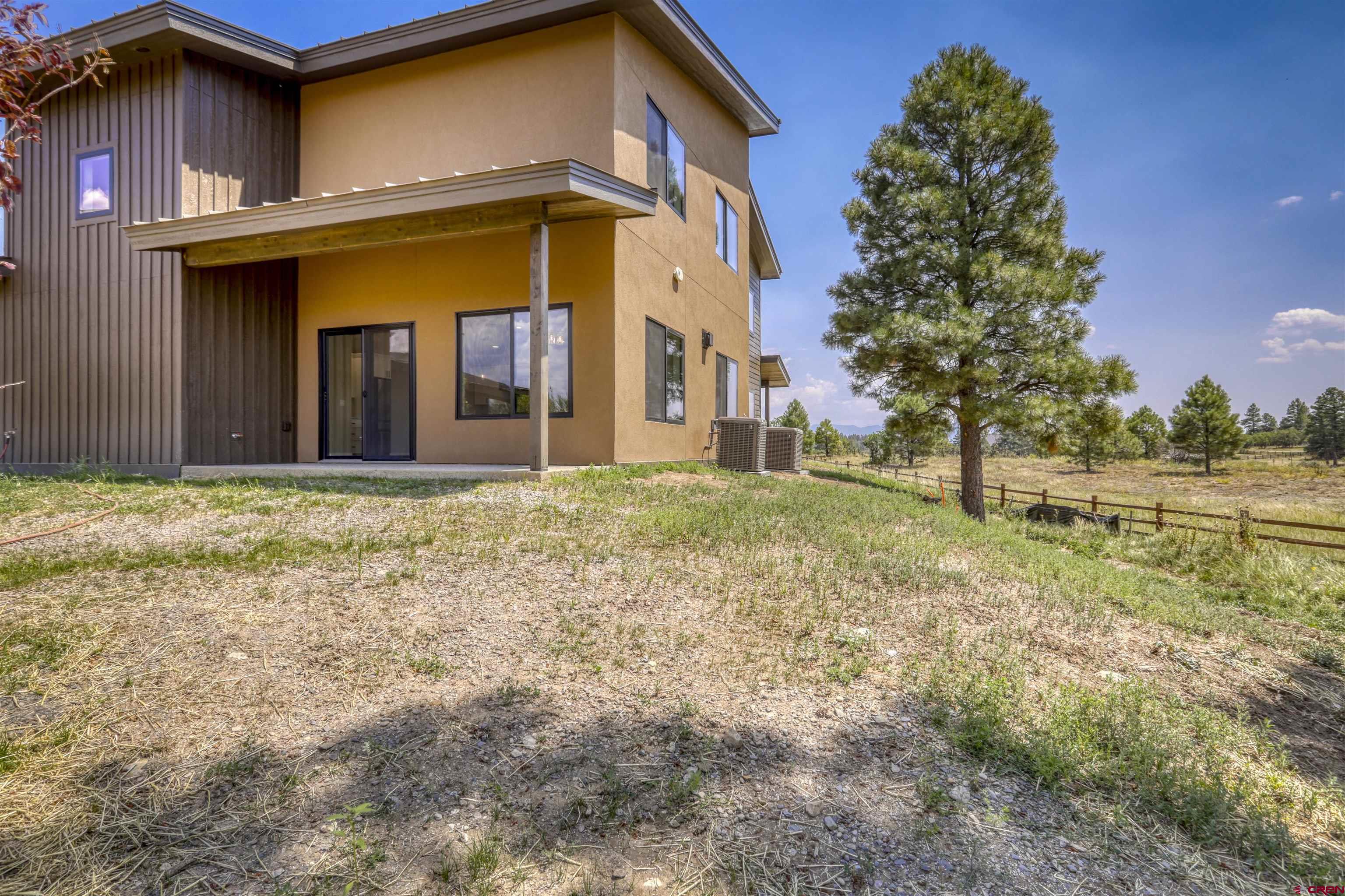 2790 Rock Road, Unit C Pagosa Springs, CO 81147 - Photo 4 of 44 a view of a house with a yard