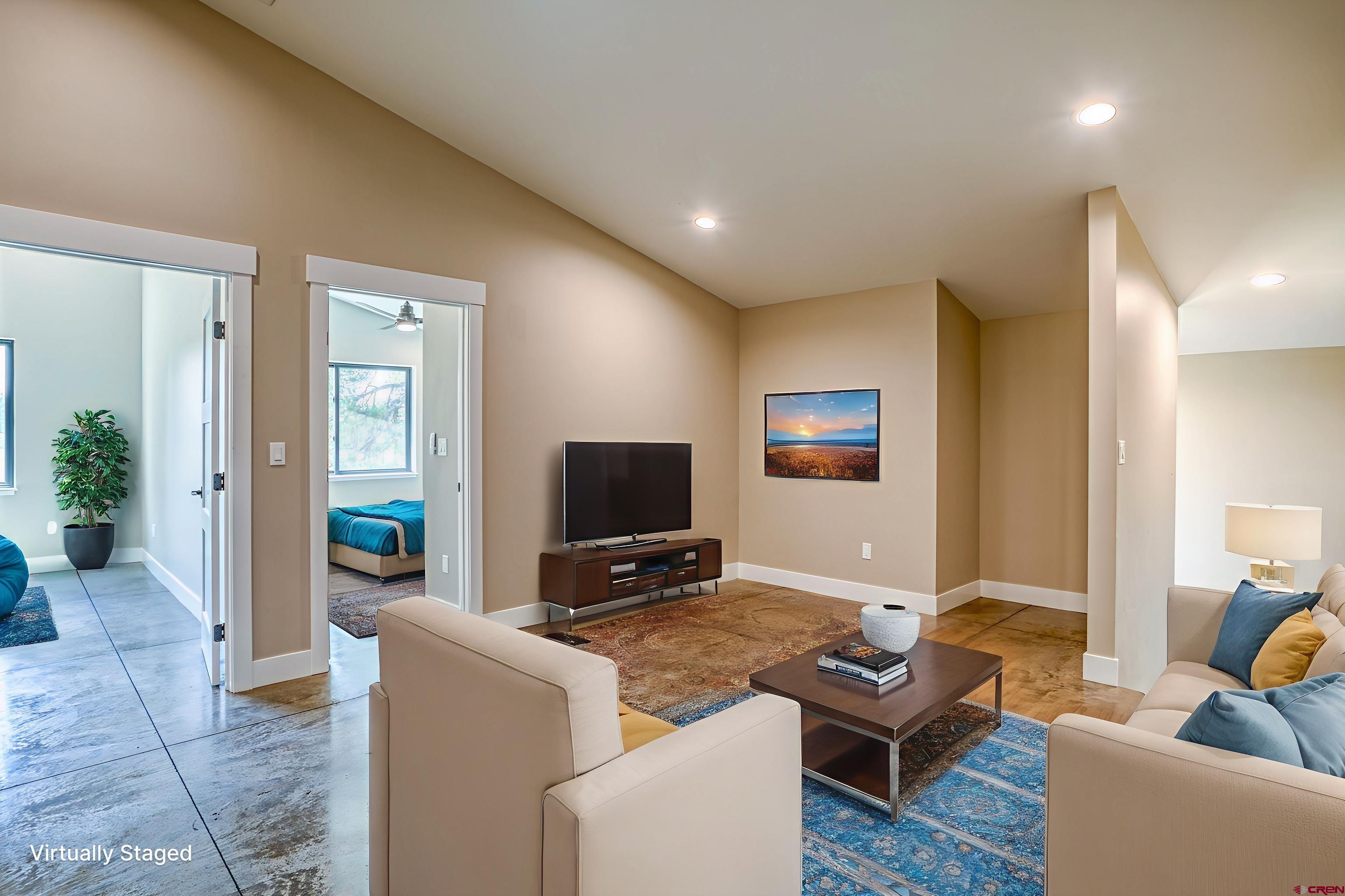 2790 Rock Road, Unit C Pagosa Springs, CO 81147 - Photo 9 of 44 a living room with furniture and a flat screen tv