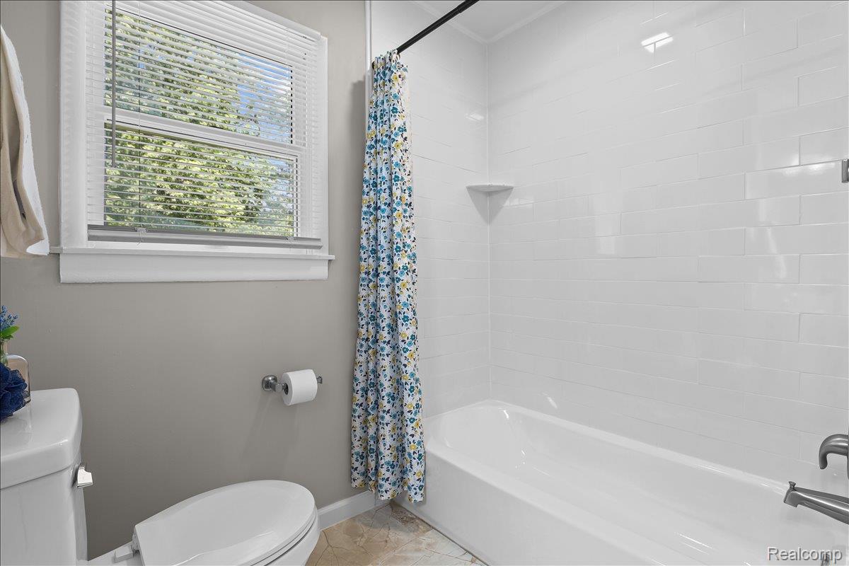 43600 Crowley Road Belleville, MI 48111 - Photo 18 of 33 Bathroom featuring a white subway tile shower surround and a white bathtub