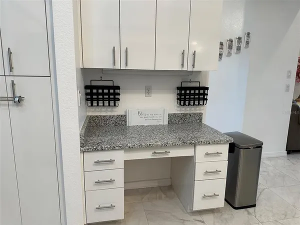a kitchen with granite countertop a sink and cabinets