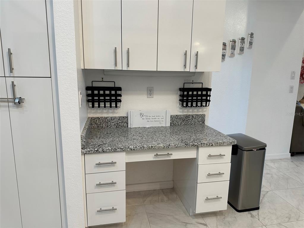 1238 Yorkshire Street Port Charlotte, FL 33952 - Photo 11 of 40 a kitchen with granite countertop a sink and cabinets