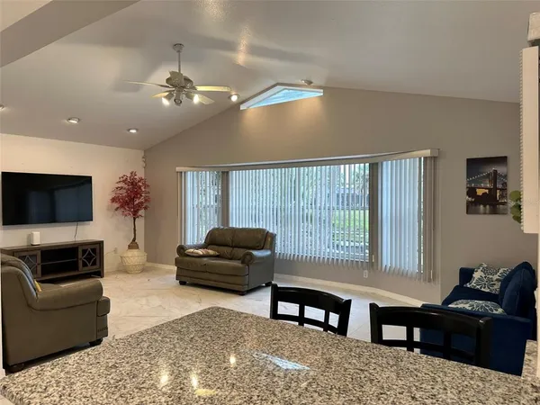 a living room with furniture fireplace and flat screen tv
