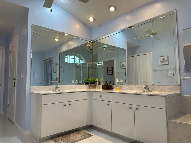 a view of bathroom with a sink mirror and a shower