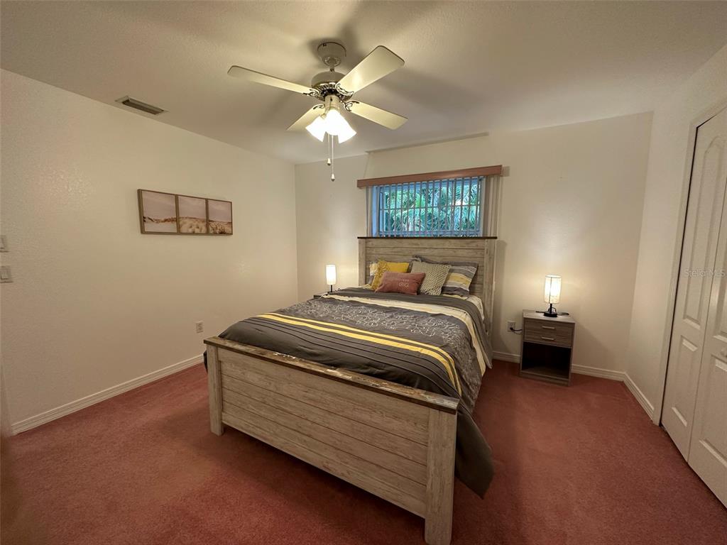 1238 Yorkshire Street Port Charlotte, FL 33952 - Photo 26 of 40 a bedroom with a bed and a lamp