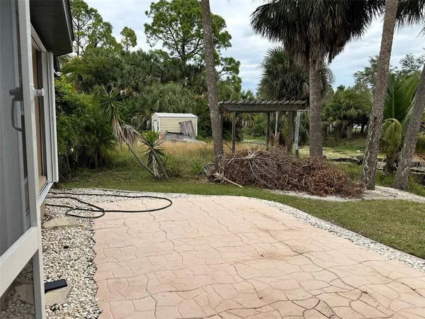a view of backyard of house and garden