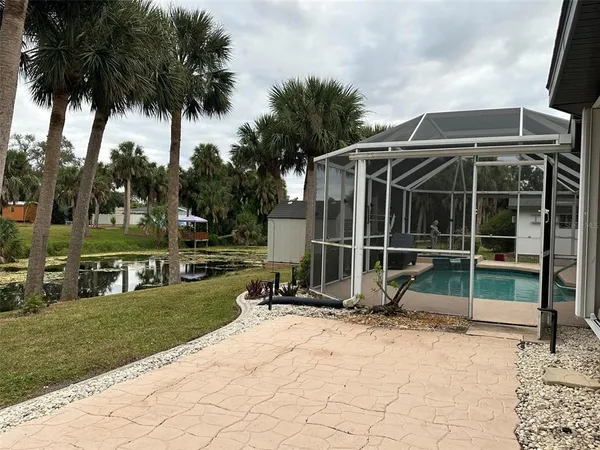 a view of backyard with wheel chair and wooden fence